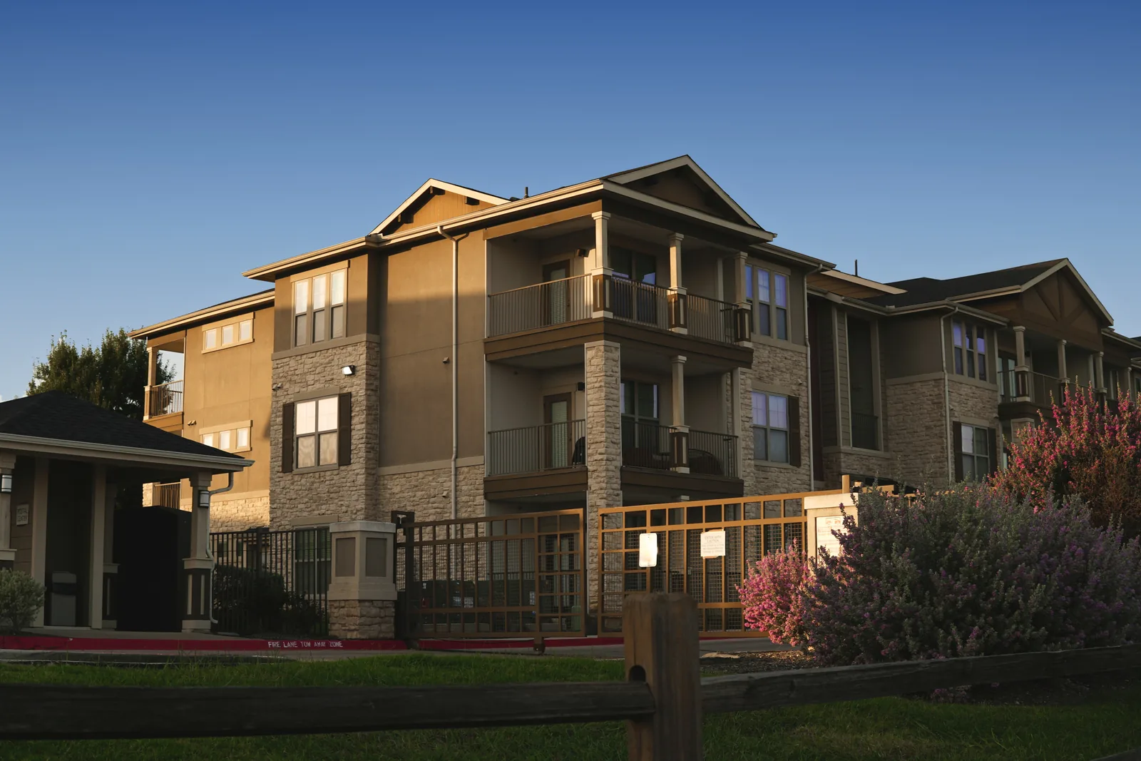 Three-story apartment building with balconies.