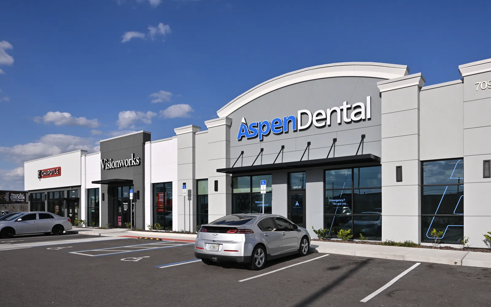 Retail center with Aspen Dental and Visionworks storefronts.